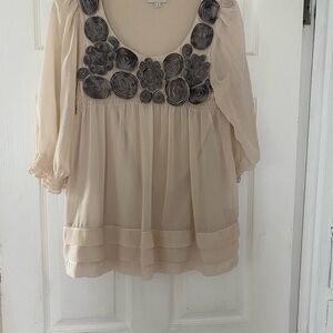 Cream polyester and rayon blouse with black rose detail. Fully lined. Size small